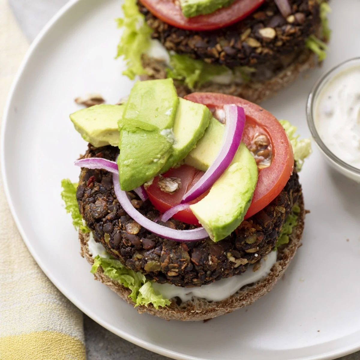 A close-up of a plated Zesty Black Bean Burger, showcasing textures of a fresh, wholesome meal.