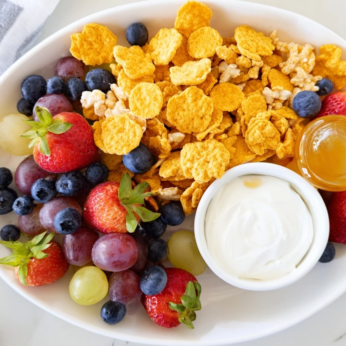 Get a close-up of the rainbow Goldfish crackers, fresh fruit pieces, and creamy yogurt dip.
