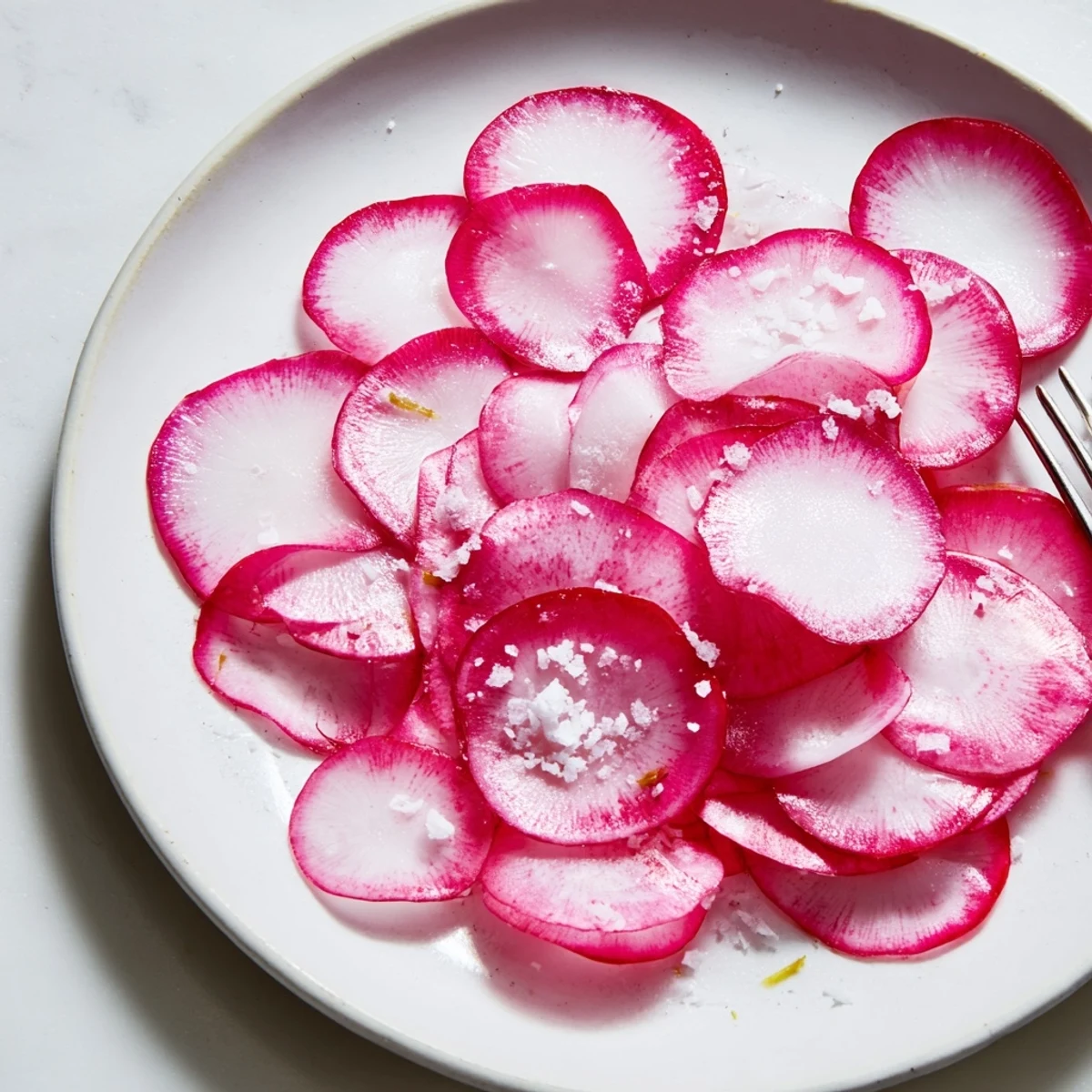 Thinly sliced Radish Slices with Sea Salt, a vibrant, refreshing snack ready for enjoying.