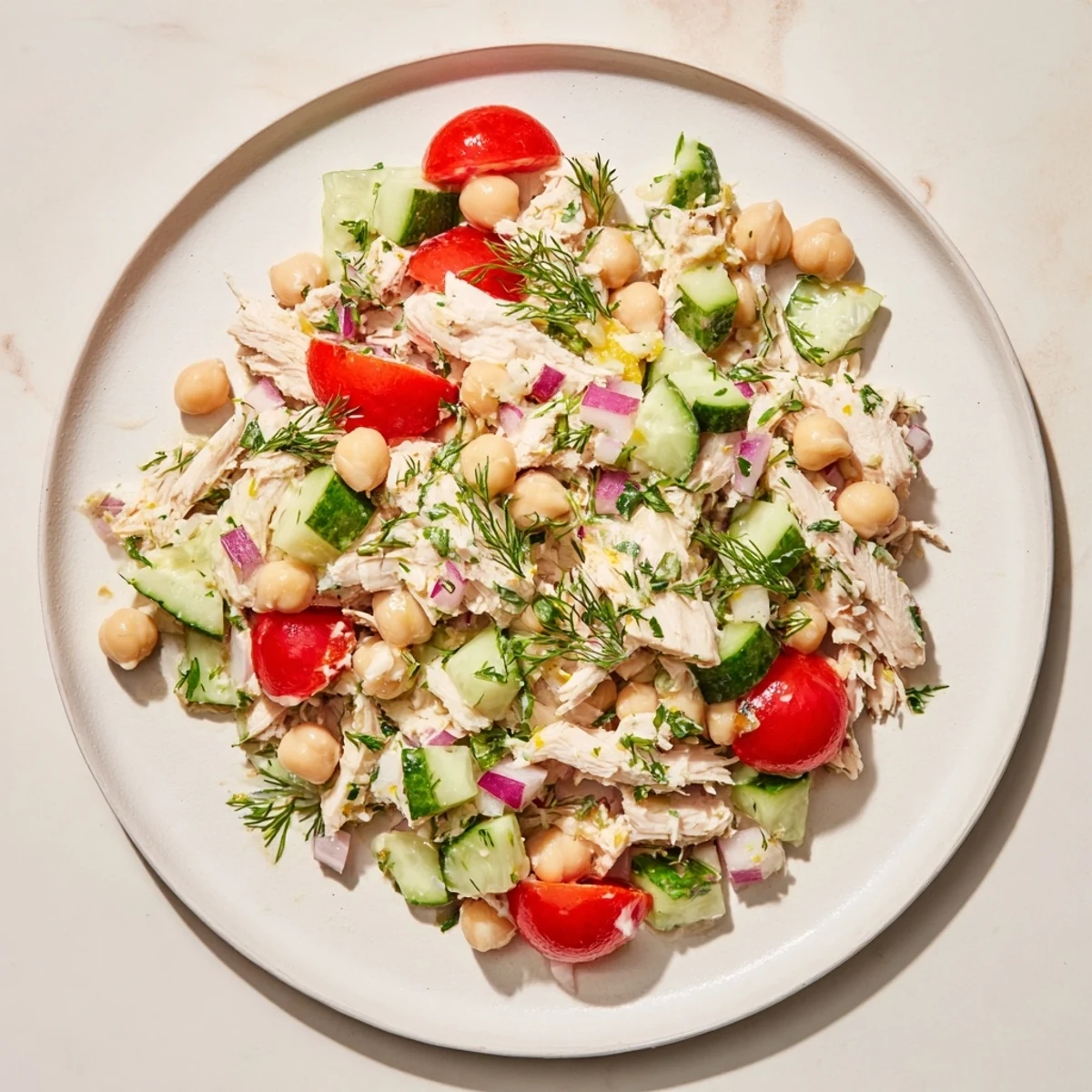 Shredded chicken and vibrant veggies highlight this delicious dense bean salad with lemon-dill flavors.