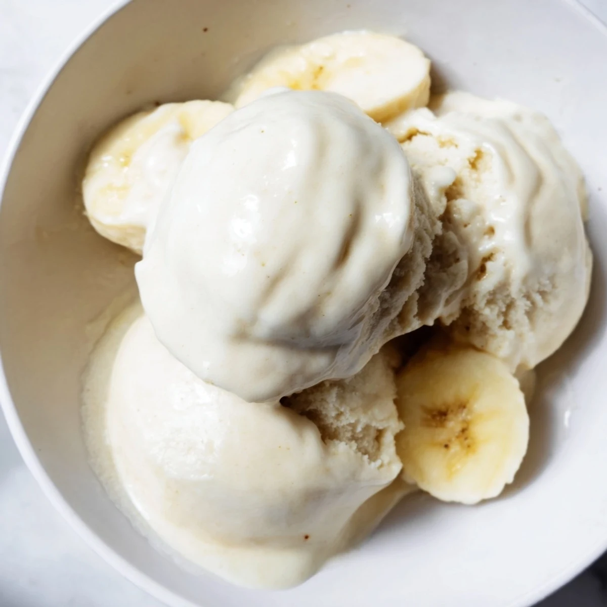 Simple 2-Ingredient Banana Ice Cream, featuring frozen banana slices, blended until smooth and ready to scoop.