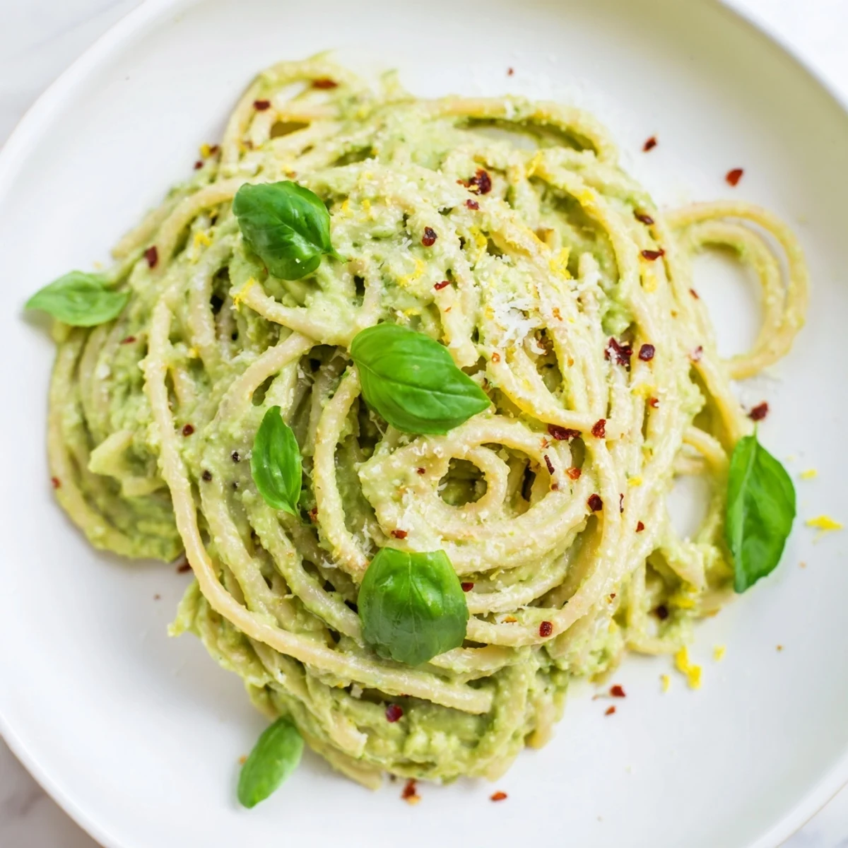 Close-up of a bowl of delicious Creamy Avocado Pasta with a delightful, smooth sauce texture.