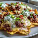 Hearty BBQ Beef Nachos loaded with smoky beef, fresh cilantro, and diced tomatoes for game day.