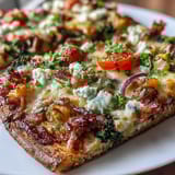 Vibrant St. Patrick's Day Rainbow Veggie Flatbread Pizza with colorful fresh vegetables arranged in festive rainbow rows.