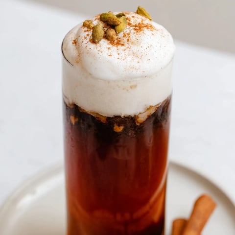 Homemade Iced Chai with cold foam, a beautifully layered drink with creamy foam atop a spiced chai.