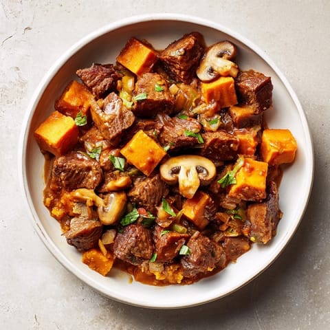 Hearty earthy beef stew with vegetables, perfect with a slice of golden homemade bread.