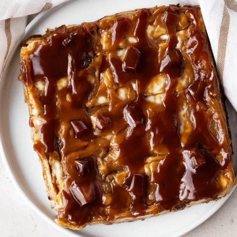 Warm, caramelized Weekend Cabin-Style Sticky Toffee Pudding drizzled with glistening, rich toffee sauce.