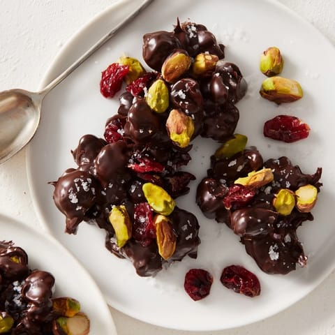 Arrangement of Pistachio and Dried Cranberry Clusters on a baking sheet, ready to cool.