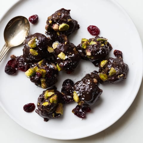 Close-up of tempting Pistachio and Dried Cranberry Clusters, showcasing visible pistachios and chocolate.