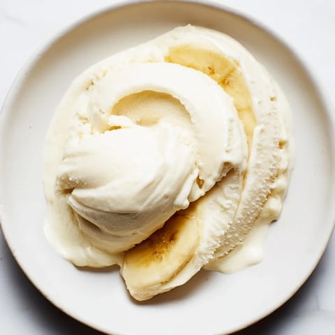 Homemade 2-Ingredient Banana Ice Cream offers a sweet, naturally frozen delight, pictured in a serving bowl.