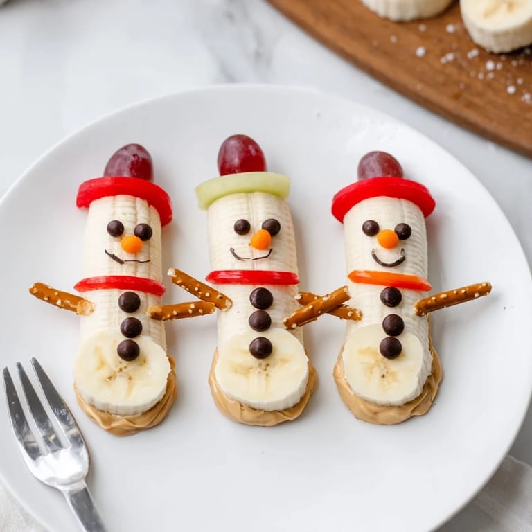 Fun holiday snack with cute Banana Peanut Butter Snowmen, ready to eat with creative edible details.
