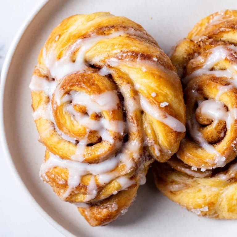 Freshly baked Air-Fryer Cinnamon Roll Twists with a delicious swirl of cinnamon sugar, ready to eat now!