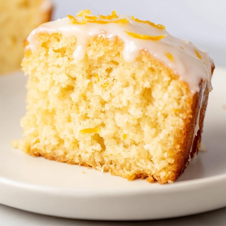 A close-up of a golden-brown Lemon Yogurt Cake, perfect for breakfast or dessert enjoyment.